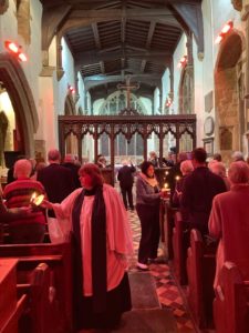 interior of church with people lighting candles