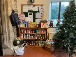 Christmas tree and shelves full of tins of food