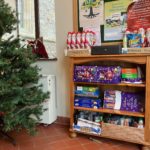 Christmas tree and shelves containing Christmas selection boxes and chocolate santas
