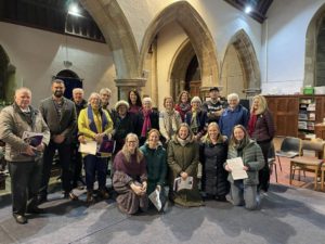 people wrapped up warmly in church at a choir practice