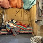 child wearing biblical clothes lying in a tent